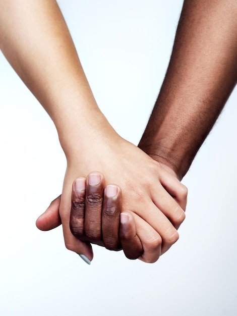 People holding hands for solidarity support on studio white background for comfort kindness or compassion Friends community and trust together or helping loyalty for grief hope unity or touch