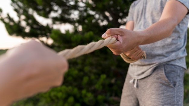 People holding a rope tight