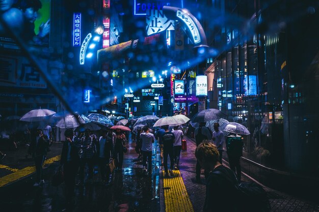 People in illuminated city at night