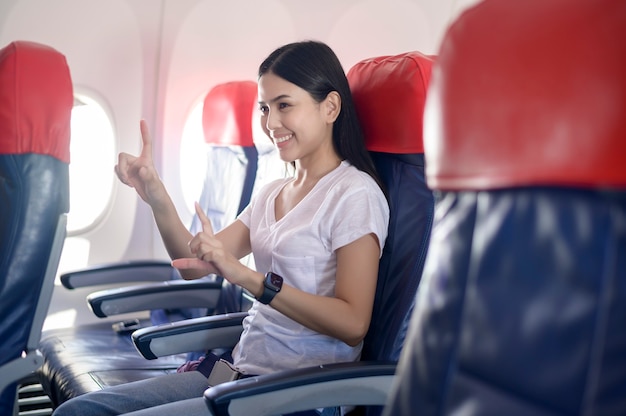 People is touching virtual screen in airplane , modern technology and transportation concept.