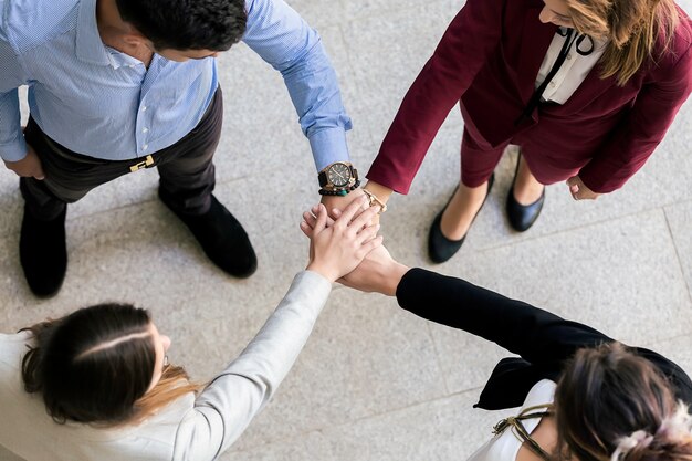 People joining hands during team building