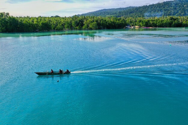 People on lake against trees