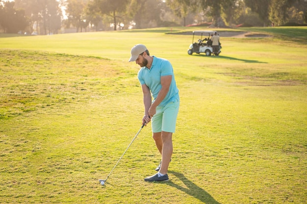 People lifestyle professional man playing game on green grass\
summer activity professional sport outdoor male golf player on\
professional golf course portrait of golfer in cap with golf\
club