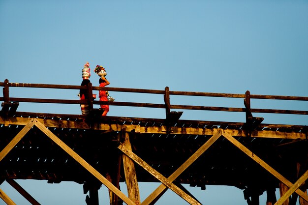 People Lifestyle at Sangklaburi or Myanmar tall wooden bridge on Songaria River, Famous tourist destination beautiful view and local traditional culture.