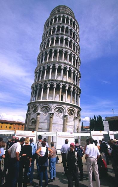 People looking at leaning tower of pisa against sky