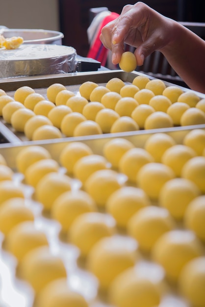 People make dough of nastar on a tray