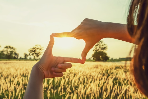 People make hand framing looking distant view