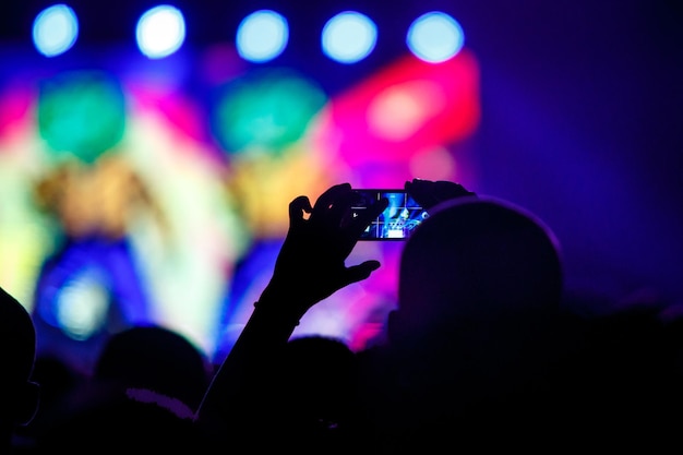 Photo people makes photo with his smartphone on concerts