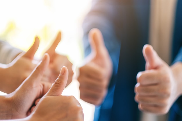 people making thumb up sign in circle