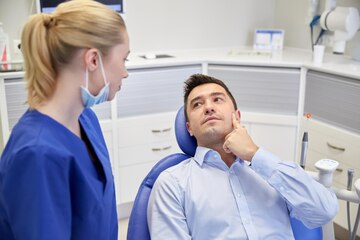 Premium Photo | People, medicine, stomatology and health care concept -  woman patient talking to male dentist and complain of toothache at dental  clinic office