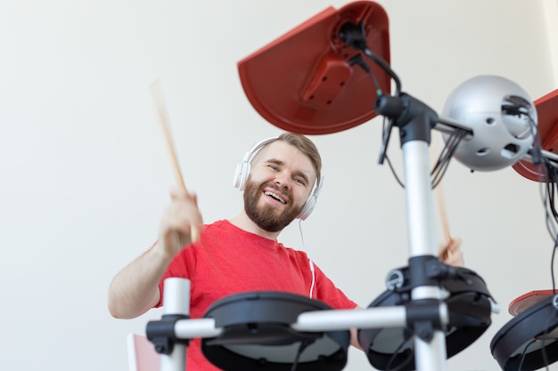 People, music and hobby concept - bottom view of the drummer.