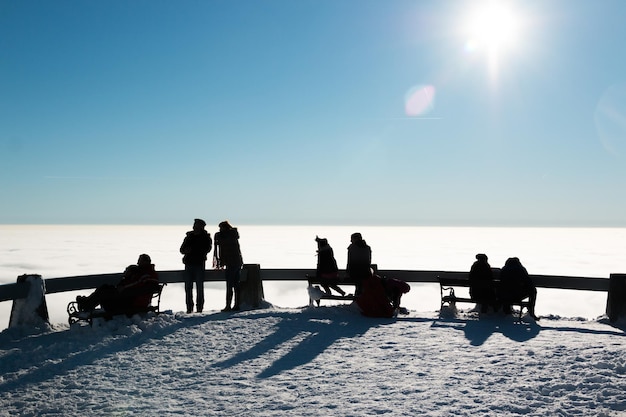 People at observation point by sea during winter