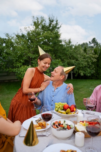 People outdoors in the garden celebration a senior birthday party