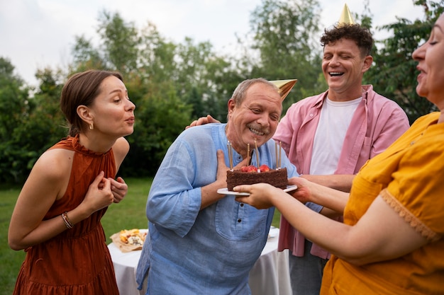 People outdoors in the garden celebration a senior birthday party