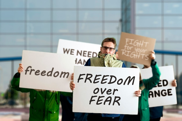 The people outside in the streets with banners on the protest march, politics event