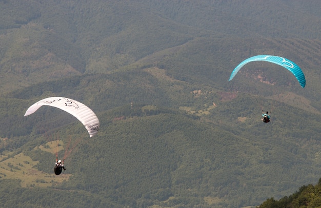 People paragliding on beautiful mountains
