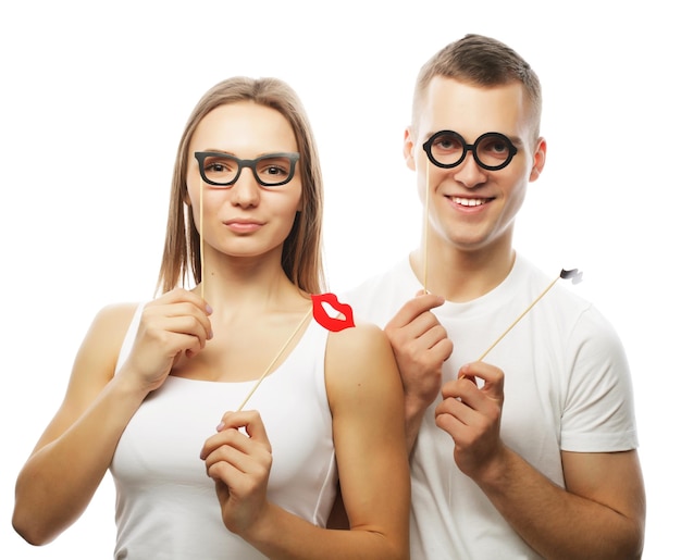 people party love and leisure concept lovely couple holding party glasses and mustaches on sticks over white background