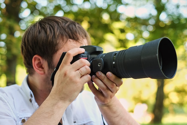 People photography technology leisure and lifestyle hipster man holding digital camera with big lens