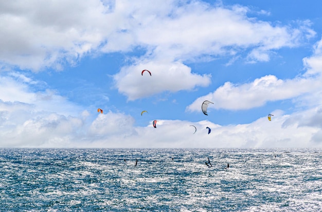 People practicing kitesurfing on Los Caos de Meca beach, Trafalgar Lighthouse, Barbate, Cadiz.