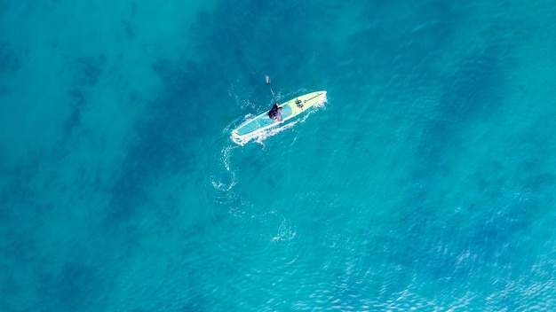 People practicing paddleboarding on the sea