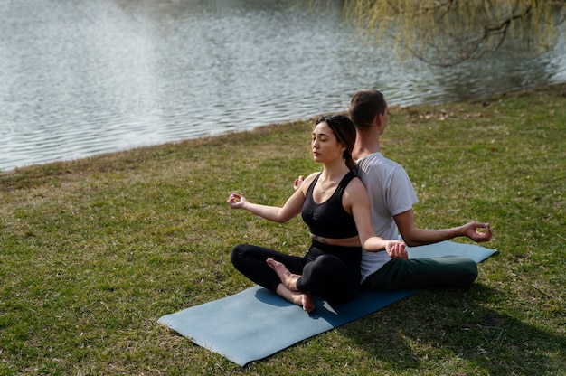 People practicing yoga outside