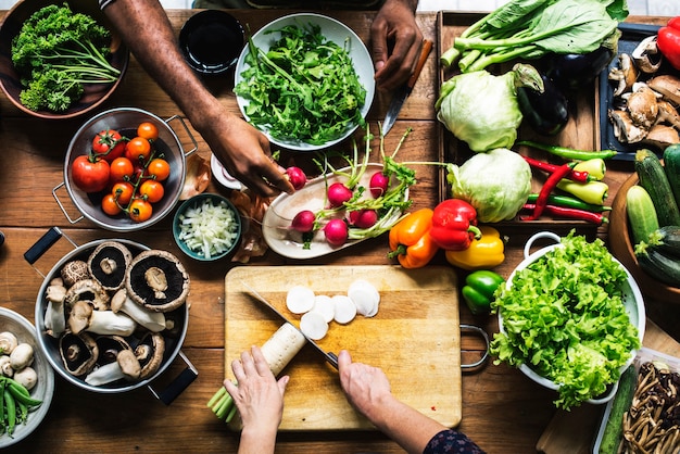 People prepare a fresh vegetable