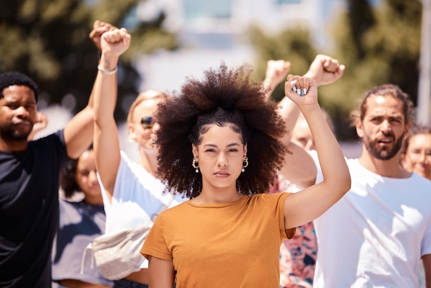 Photo people protest for freedom support fist for climate change or black power empowerment in los angeles young woman community rally together to fight for future human rights or global revolution