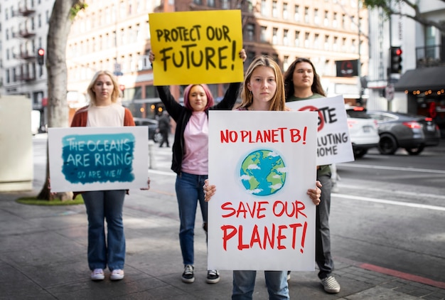 Photo people protesting with placard in the city for world environment day