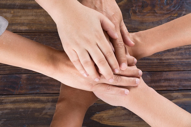 People put hand together for use as unity teamwork concept