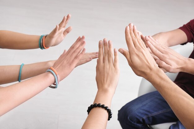 Photo people putting hands together as symbol of unity