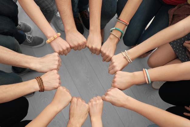 Photo people putting hands together as symbol of unity