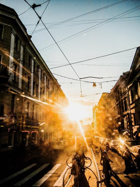 People on railroad tracks against sky