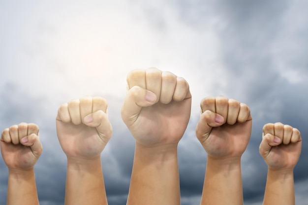 People raised fist air fighting for their rightslabor movement\
conceptlabour day conceptworkers marched to claim the benefits