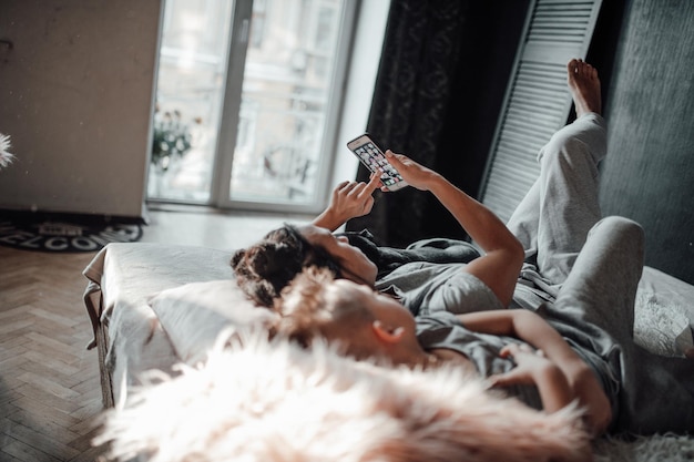 People relaxing on bed at home