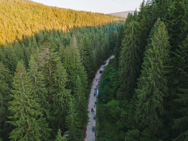 People riding atv at ukrainian carpathian mountains overhead view