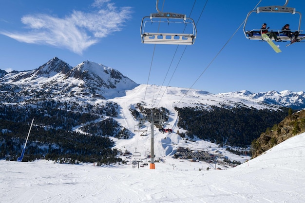 People riding ski lift in ski resort