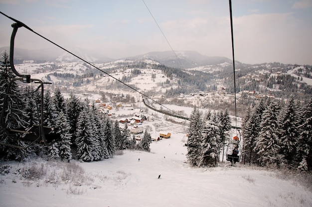 People rises on the lift in Carpathian mountains. Close up. Winter nature. Heavy snow falls. top view. and looking down.