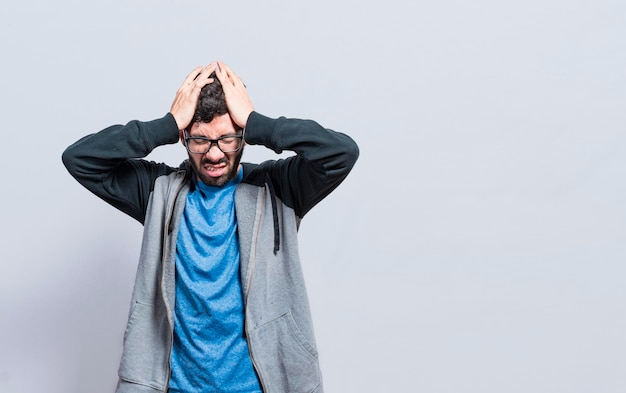 People rubbing his head on isolated background Concept of a person with a headache guy giving himself a head massage concept of a man with a migraine