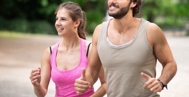 People running in a park, cardio and stamina workout outdoor. Shallow depth of field