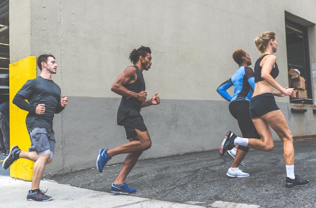 People running on road in city