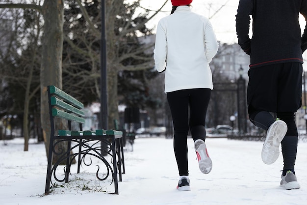 People running in winter park closeup Outdoors sports exercises