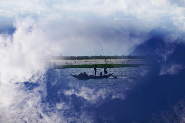 People sailing on sea against sky