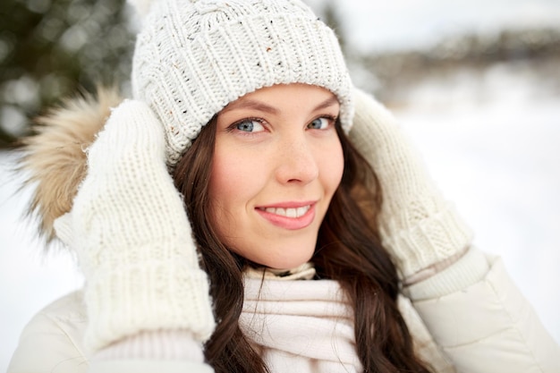 people, season and leisure concept - happy woman outdoors in winter