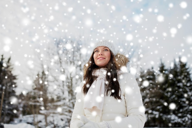 people, season and leisure concept - happy woman outdoors in winter