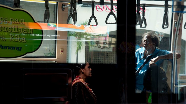 Photo people seen through bus window