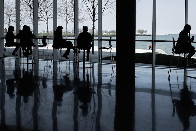 People sitting in restaurant with reflection on floor