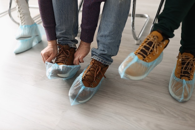 People sitting in shoe covers