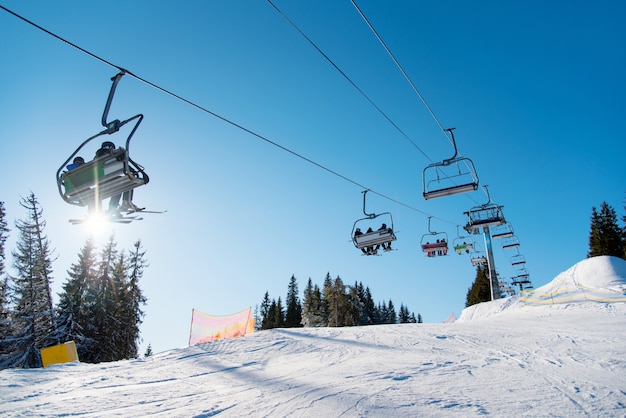 People on ski lift in the mountains