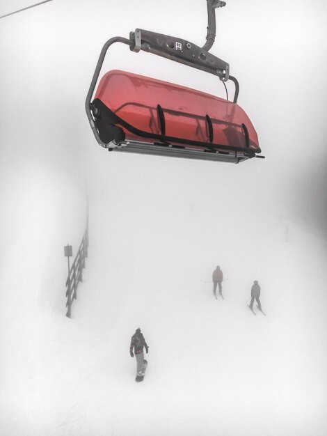 People skiing below ski lift