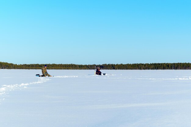 People on snow against sky